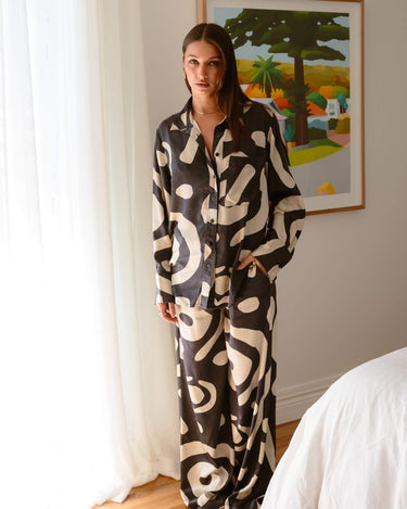 Standing view of KENI Sleepwear Bright Eyes Silk Pants ultra luxurious styled with matching silk shirt