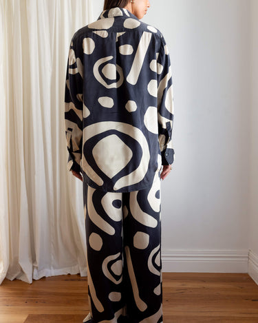 Shot from behind of KENI Sleepwear Bright Eyes Silk Shirt - relaxed fit, generous bottom hem and styled with matching pants