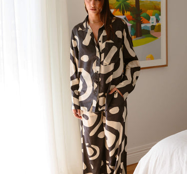 Standing view of KENI Sleepwear Bright Eyes Silk Pants ultra luxurious styled with matching silk shirt