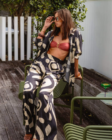 Model wearing KENI Sleepwear wide-leg silk pants, showing elasticated waist and relaxed fit